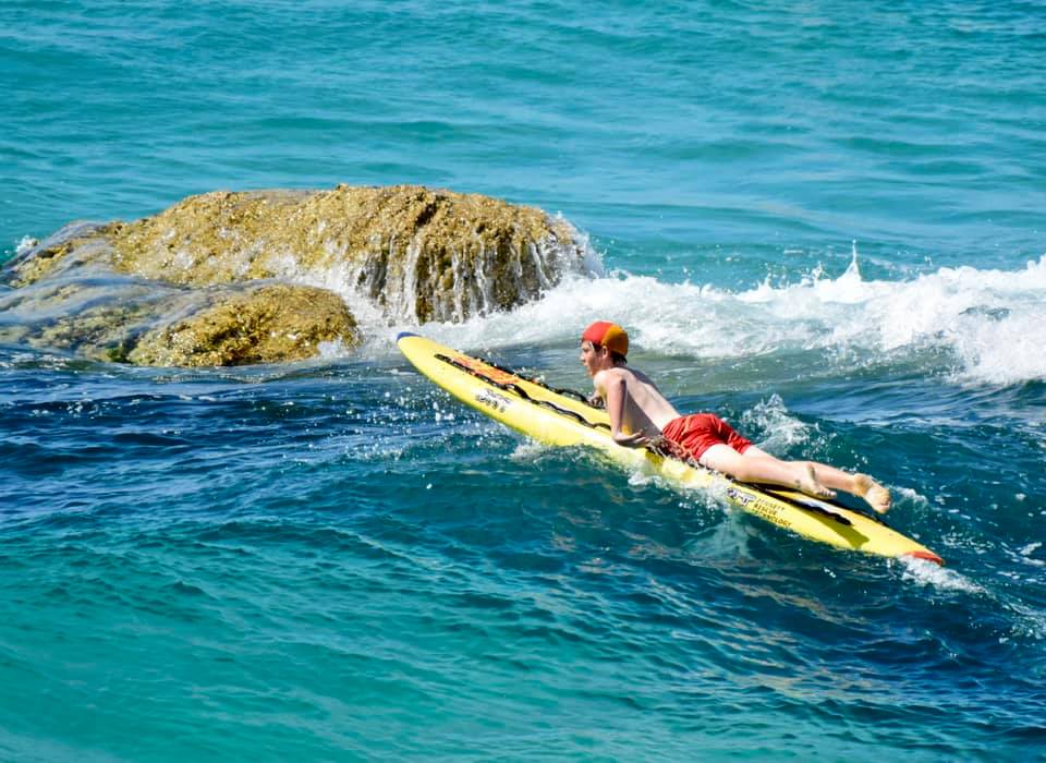 boy lifesaver on paddle board