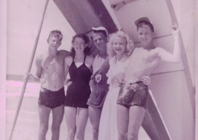 menu and women standing under surfboard vintage