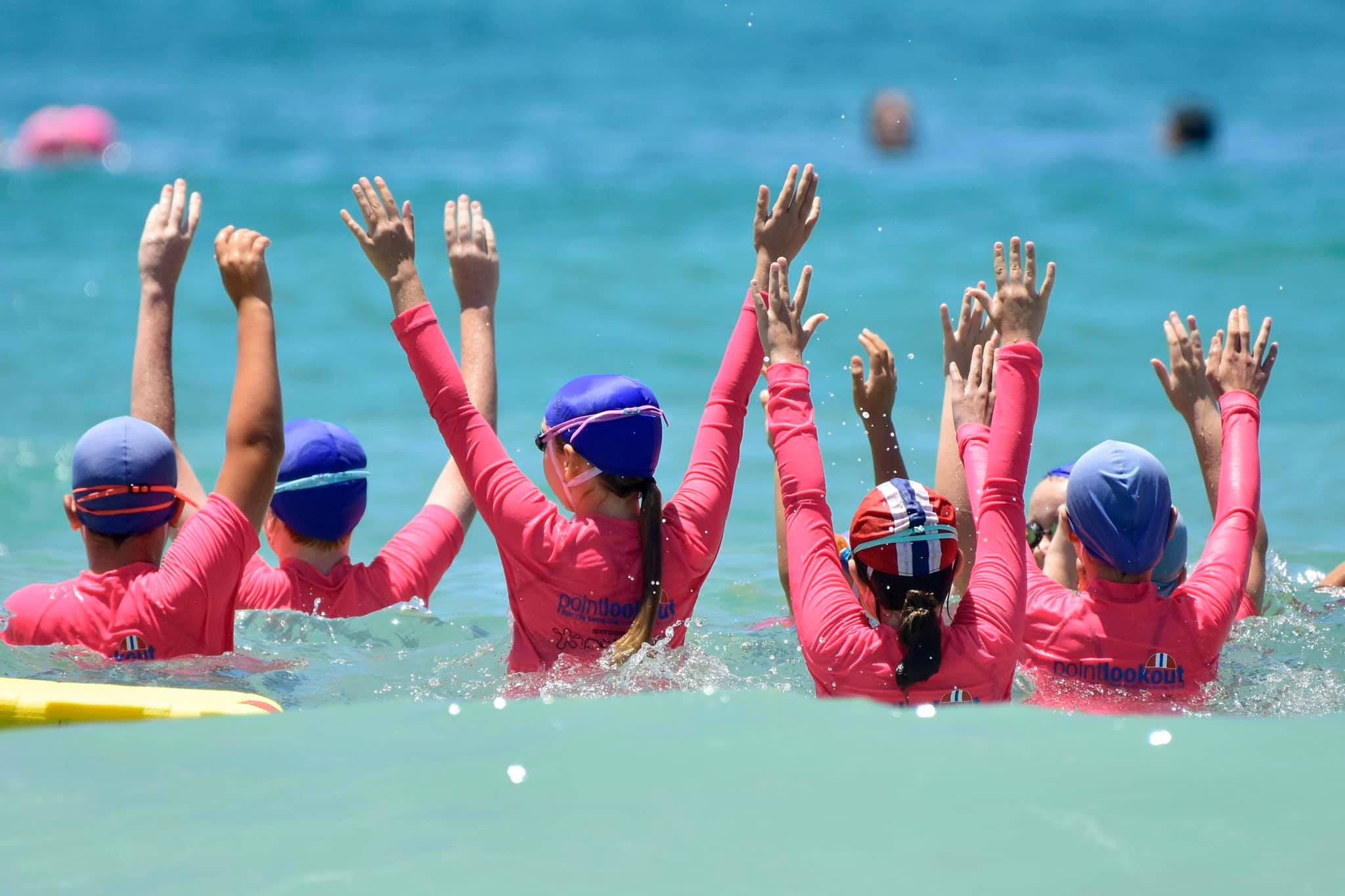 lifesavers on inflatable rescue boat supervising nippers in ocean at point lookout surf lifesaving club