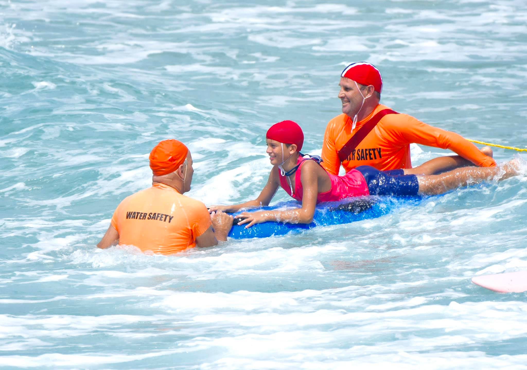 lifesaver supervising young child in nippers for water safety