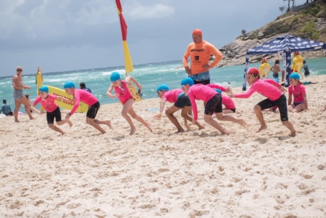 lifesavers on inflatable rescue boat supervising nippers in ocean at point lookout surf lifesaving club